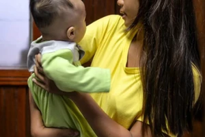 Mary bế cậu con trai Michael. Ảnh: Sherlyn Seah/SCMP