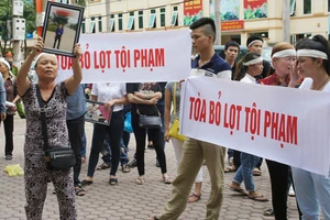 Người nhà căng băng rôn sau khi toà tuyên án kẻ bắn chết sinh viên