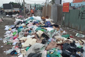 Dù UBND phường đã cắm bảng cấm, nhiều người vẫn đem rác ra vứt ở bên lề Quốc lộ 1A (gần số 2963-2965, QL 1A, phường Tân Thới Nhất, quận 12, TP.HCM). Ảnh: TRẦN ĐĂNG QUANG