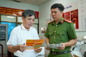 Ông Phạm Văn Cư, ngụ khu phố 3, phường 10, quận 5, trao đổi với cảnh sát khu vực Đào Minh Luân về công tác phòng, chống cháy nổ.