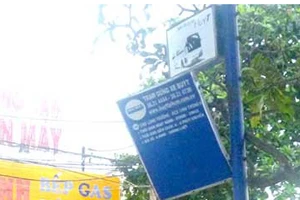 Bảng dừng xe buýt sắp rơi gây nguy hiểm