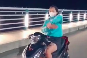 Cô gái buông tay lái xe máy, múa quạt giống Khá Bảnh