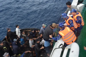 Tàu cảnh sát biển tiếp nhận ngư dân trên tàu câu mực cháy ở Trường Sa