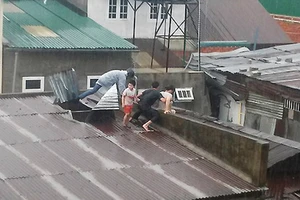 Bơi qua dòng lũ nhiễm điện cứu 3 mẹ con kẹt trong nhà sập