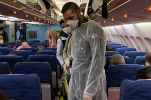 Hành khách trên chuyến bay di tản công dân của Pháp ngày 2-2. Ảnh: AFP