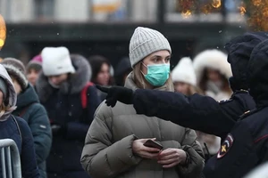 Một nhân viên an ninh hướng dẫn người dân làm thủ tục kiểm tra sức khoẻ ở ga Moscow (ảnh chụp ngày 3-2). Ảnh: TASS