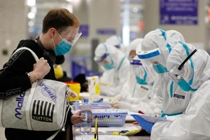 Hành khách nhập cảnh tại sân quốc tế Bắc Kinh, Trung Quốc ngày 11-2. Ảnh: AFP