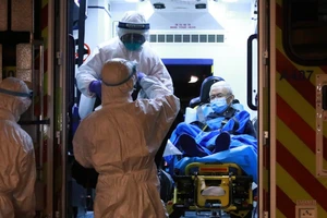 Nhân viên y tế Hong Kong di chuyển một bệnh nhân nhiễm COVID-19 (Ảnh chụp ngày 29-3). Ảnh: SCMP