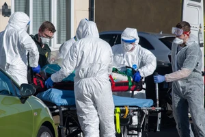 Nhân viên y tế di chuyển bệnh nhân nhiễm COVID-19 ở thị trấn Watford, Anh ngày 2-4. Ảnh: BBC