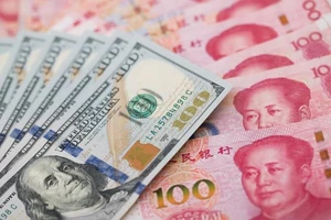 Đồng đô la Mỹ và đồng nhân dân tệ. Ảnh: GETTY IMAGES