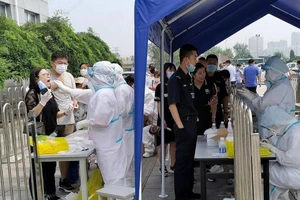 Người dân TP Đại Liên xếp hàng chờ xét nghiệm. Ảnh: REUTERS