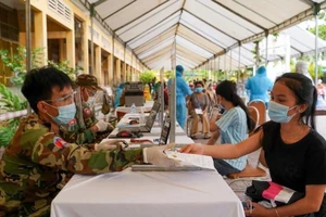 Người dân Campuchia khai báo y tế trước khi được tiêm vaccine ngừa COVID-19.