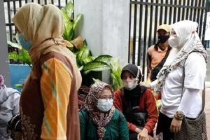 Người dân thủ đô Jakarta (Indonesia) xếp hàng chờ tiêm vaccine ngừa COVID-19. Ảnh: REUTERS