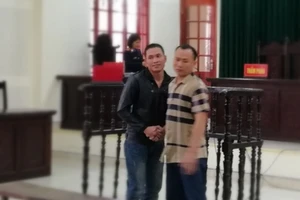 Hai bị cáo bắt tay vui mừng vì cùng được giảm án