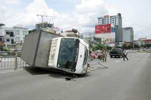 Xe tải lật nhào trên cầu vượt bằng thép