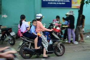 Nhiều phụ huynh vẫn phớt lờ đội mũ bảo hiểm cho con