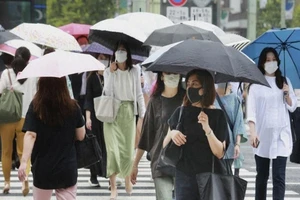 Người dân Tokyo mang khẩu trang khi ra đường. Ảnh: AP