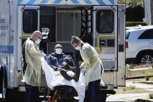 Di chuyển một bệnh nhân vào xe cấp cứu ở quận Manhattan, TP New York, bang New York (Mỹ), ngày 26-3. Ảnh: REUTERS