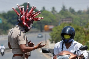 Cảnh sát TP Chennai, bang Tamil Nadu (Ấn Độ) đội mũ bảo hiểm có hình dạng con virus corona ra tuần tra đường phố và yêu cầu dân quay về nhà. Ảnh: REUTERS