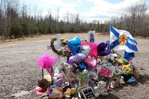 Hoa được đặt tại địa điểm một phụ nữ mang thai đứa con thứ ba bị bắn chết trong vụ xả súng ở tỉnh Nova Scotia (Canada). Ảnh: REUTERS