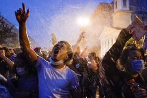 Biểu tình dưới mưa tại thủ đô Washington DC tối 4-6. Ảnh: AP