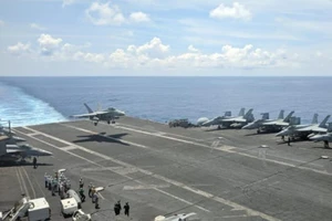 Máy bay chiến đấu đa năng của Hải quân Mỹ hạ cánh trên boong tàu sân bay USS Ronald Reagan di chuyển trên Biển Đông. 
