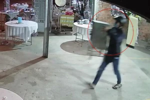 Nam thanh niên ôm thùng phúng điếu bỏ chạy. Ảnh: Cắt từ camera