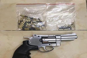 Khẩu súng và đạn thu giữ trên người bị can Phạm Ngọc Tân. Ảnh: CA
