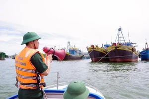 Bộ đội Biên phòng Bình Thuận hướng dẫn các tàu thuyền neo đậu an toàn. Ảnh TT. 