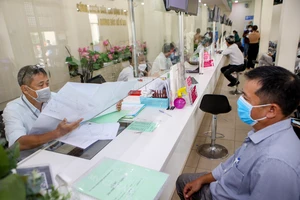 Cán bộ quận Bình Tân đang giải quyết hồ sơ cho người dân. Ảnh: NGUYỆT NHI