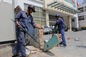 Quận 1 đập tường lấn vỉa hè, cẩu xe xanh vi phạm
