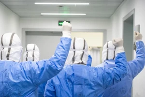 Nhân viên y tế tại Vũ Hán, Trung Quốc nâng cao tinh thần của họ bằng cách cổ vũ cho nhau.