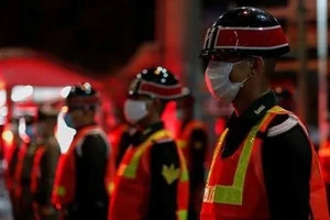 Quân cảnh Thái Lan đứng gác tại một chốt kiểm soát ở Bangkok đêm 3-4. Ảnh: REUTERS