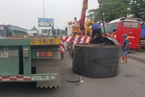 2 cuộn thép hàng chục tấn trên xe đầu kéo rơi xuống quốc lộ qua TP.HCM 