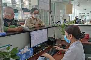 Người dân đến đăng ký khám chữa bệnh BHYT tại BV quận Gò Vấp. Ảnh: NGUYỄN HIỀN