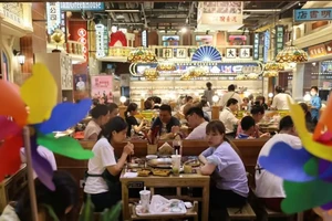 Người dân Trung Quốc dùng bữa tại một nhà hàng trong khu mua sắm ở Bắc Kinh vào ngày 25-7.