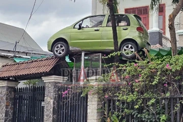 Chiếc xe ô tô ‘độc lạ’ đậu trên cổng nhà dân ở Đồng Nai đã được đưa xuống