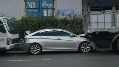 Xế hộp móp cả đầu lẫn đuôi vì nằm giữa 2 xe tải