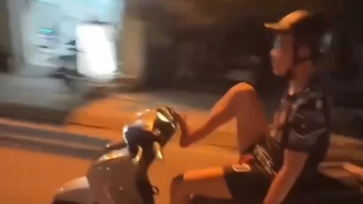 Thanh niên buông 2 tay, dùng chân lái xe máy