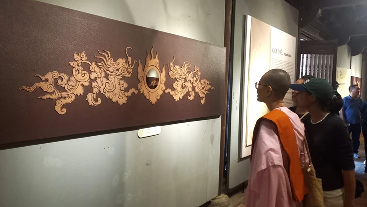 Du khách thích thú chiêm ngưỡng hoạ tiết rồng trên 82 bia Tiến sĩ 