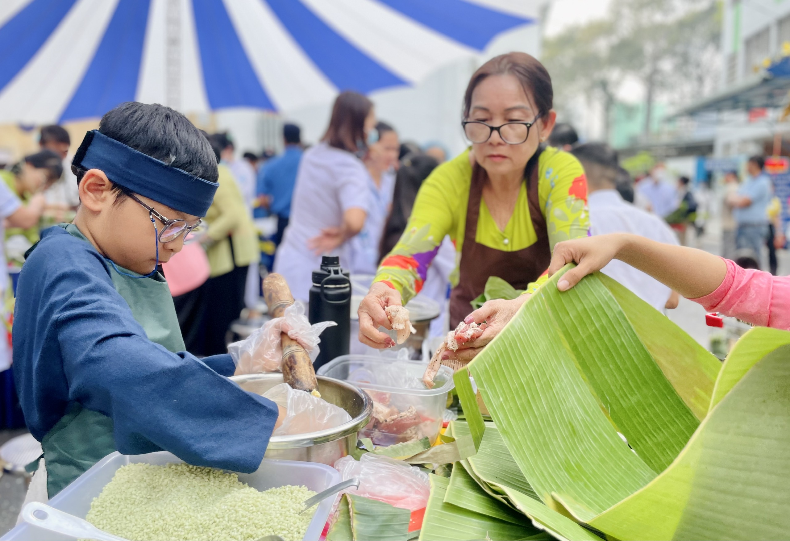 Thân nhân, bệnh nhi và nhân viên y tế thi gói bánh chưng, bánh tét