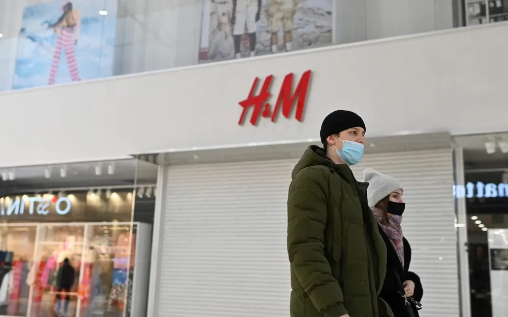 Cặp đôi đi ngang qua cửa hàng H&M đã bị đóng cửa ở Nga. Ảnh: REUTERS Cặp đôi đi ngang qua cửa hàng H&M đã bị đóng cửa ở Nga. Ảnh: REUTERS