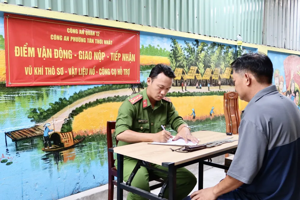 Sáng 10-11, hơn 20 người dân tại phường Tân Thới Nhất, quận 12 đã tới giao nộp các loại vũ khí như dao, mã tấu, kiếm. Ảnh: TRẦN MINH giao nộp vũ khí 1.jpg