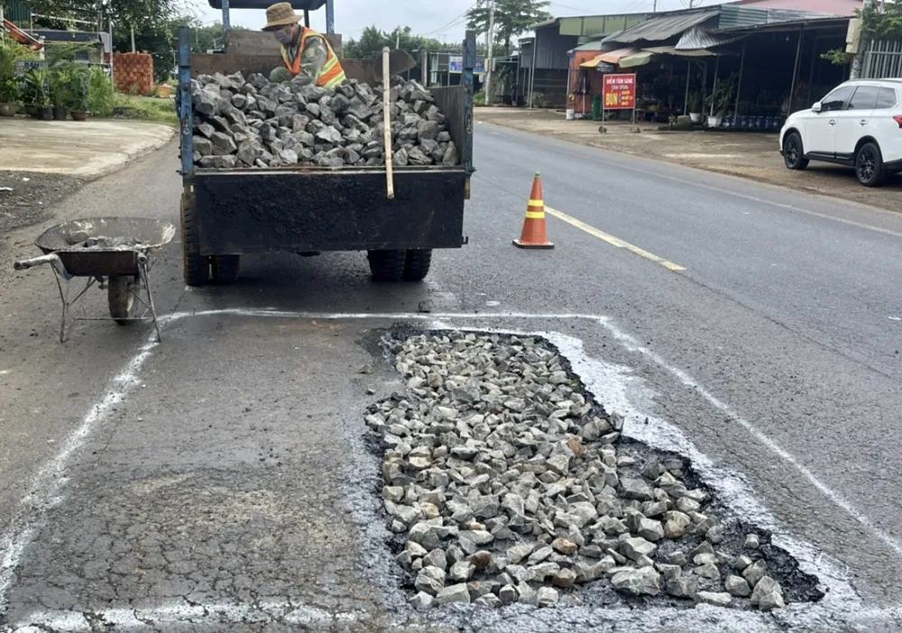 "Vá" mặt đường Quốc lộ 14 đoạn qua huyện Cư Jút (Đắk Nông). Ảnh: TNT "Vá" mặt đường Quốc lộ 14 đoạn qua huyện Cư Jút (Đắk Nông). Ảnh: TNT