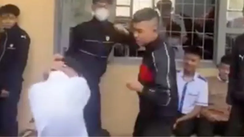 Nam sinh áo trắng bị nhóm học sinh tấn công. Ảnh cắt từ clip Nam sinh bị tấn công