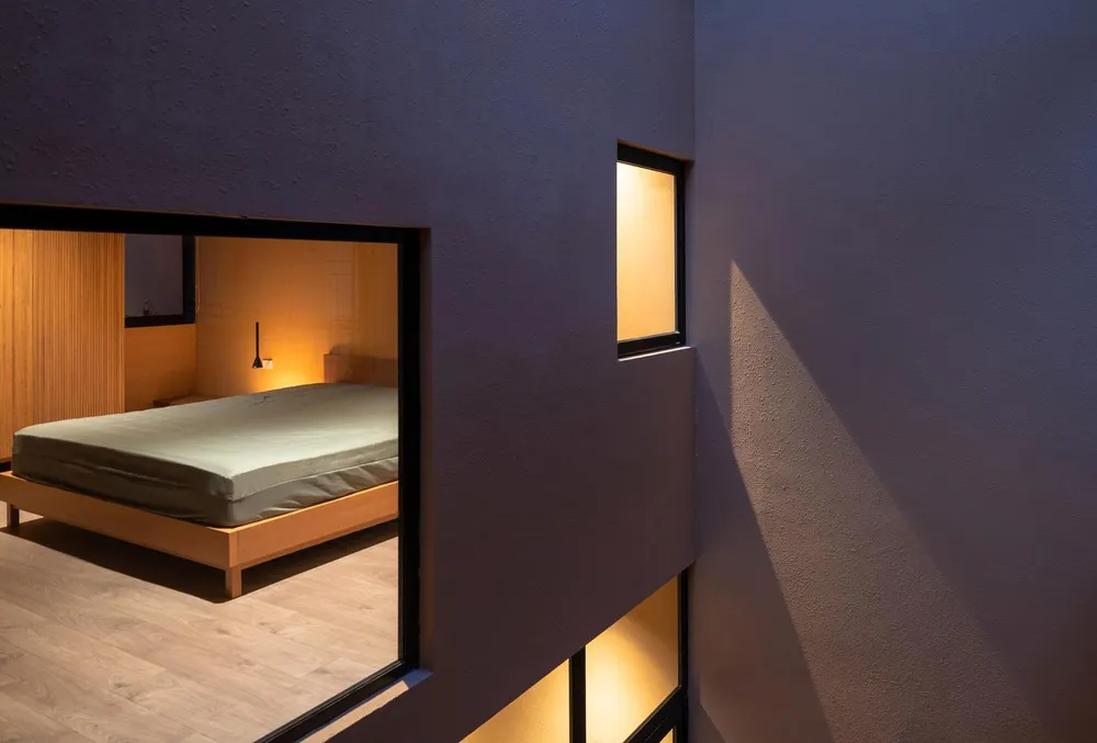 Nội thất phòng ngủ bố trí cơ bản gồm giường ngủ, đèn gắn tường, tủ quần áo có chiều cao phù hợp.