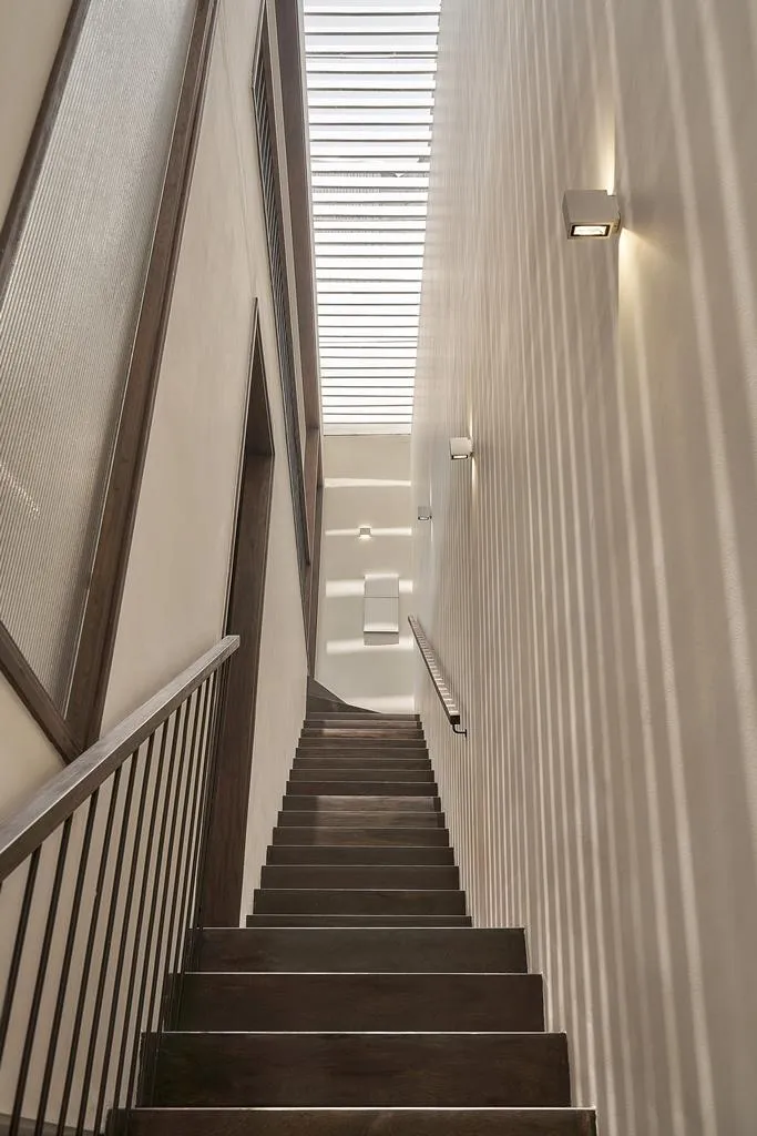 Cầu thang dẫn lên tầng lầu lấy sáng từ việc thiết kế giếng trời.