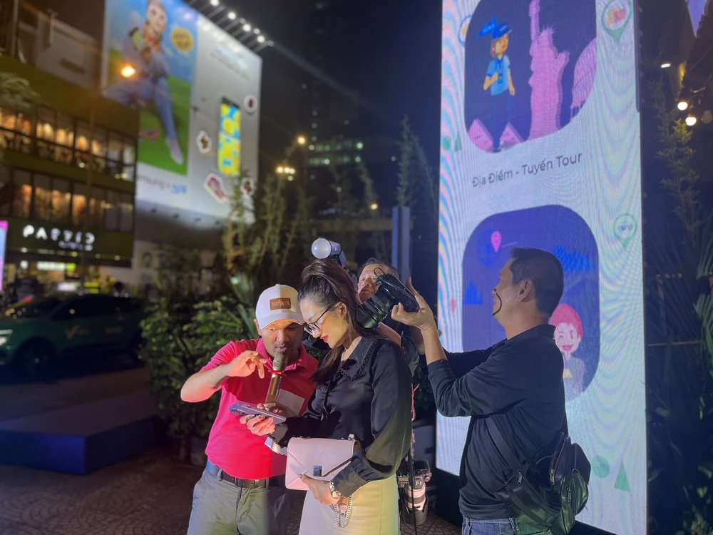 Du khách trải nghiệm cài đặt ứng dụng tour guide ảo. Ảnh: THU TRINH.