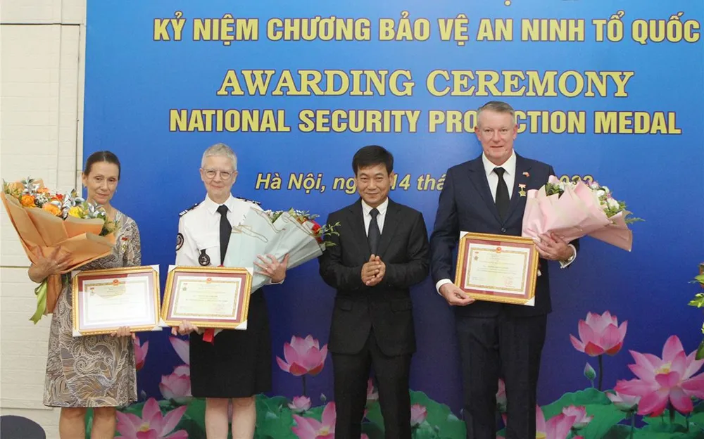 Trung tướng Đặng Xuân Hồng trao Kỷ niệm chương “Bảo vệ an ninh Tổ quốc” tặng ngài Peter James Vernon, bà Nathalie Carlier và bà Catherine Rossi. Ảnh: Bộ Công an