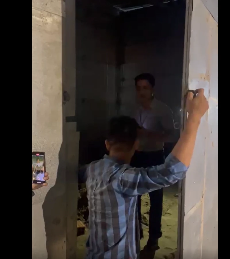 Sau 59 giây khoá cửa, ông Tâm tự động đến mở cửa bảo những cán bộ phải ra khỏi nhà. Ảnh cắt từ clip.